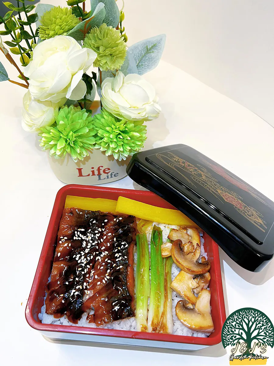 Unagi eel bento box with rice, grilled eel, mushrooms, and green onions at J&J's Garden Kitchen，a Asian Restaurant in Fredericksburg